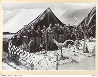 WEWAK POINT, NEW GUINEA. 1945-10-02. A SMARTNESS OF LINES COMPETITION WAS HELD AT 2/3 MACHINE-GUN BATTALION AND TROOPS WERE GIVEN A WEEK TO DECORATE THEIR LINES. THE COMPETITION WAS WON BY A 10 ..
