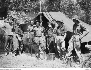 DAGUA, NEW GUINEA. 1945-03-30. D COMPANY, 2/2 INFANTRY BATTALION PERSONNEL OUTSIDE THEIR "COOKHOUSE". IDENTIFIED PERSONNEL ARE:- PRIVATE C. POPE (1); CORPORAL J.L. WILLIS (2); PRIVATE C.A. JOLLIFFE ..