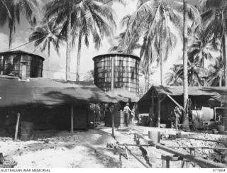 A GENERAL VIEW OF THE WATER DISTILLING PLANTS OPERATED BY NO. 2 PLATOON, 23RD FIELD COMPANY. EACH OF THESE PLANTS CAN TURN OUT 1000 GALLONS OF FRESH WATER PER HOUR. THE STORAGE TANKS AT THE REAR ..