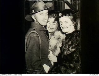 Melbourne, Vic. 1942-03. Sergeant (Sgt) Herbert William (Bert) Smith is welcomed home at Spencer Street Station by family members, his wife Liliane Smith and his mother Margaret Smith, who is ..