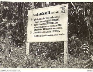 FINSCHHAFEN AREA, NEW GUINEA, 1944-03-17. ONE OF MANY BATTLE SIGNS IN THE FINSCHHAFEN AREA, THIS SIGN MARKS THE SITE OF THE HEADQUARTERS, 2/48TH INFANTRY BATTALION