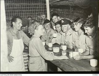 VIVIGANI, GOODENOUGH ISLAND, PAPUA. C. 1944-02-21. AMERICAN RED CROSS REPRESENTATIVE MISS BERT HENDRIE OF NEW YORK SERVING COFFEE TO RAAF PERSONNEL AT AN ADVANCED OPERATIONAL BASE. FROM LEFT: ..