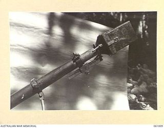 NEW GUINEA. 1943-11-24. CLOSE UP OF THE RANGE FINDER AND PULL IGNITER OF THE JAPANESE SPIGOT MORTAR (ANTI-TANK). THIS EQUIPMENT HAS BEEN PREPARED FOR DEMONSTRATION PURPOSES BY THE COMMAND ROYAL ..