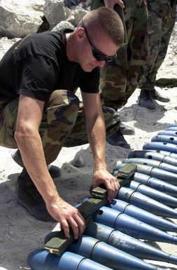 SENIOR AIRMAN (SRA) Adam Ginett of the 36th Explosive Ordnance Disposal (EOD) flight, Andersen Air Force Base (AFB), Guam, prepare to detonate ordnance on the Tarague EOD range, by laying blocks of C 4 explosives over MK 76 Marine practice bombs