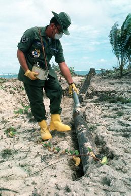 An Air Force TECH. SGT. checks for radiation on the island of Runit during a clean-up of Eniwetok Atoll. The U.S. used islands in the atoll for atomic testing in the 1950's