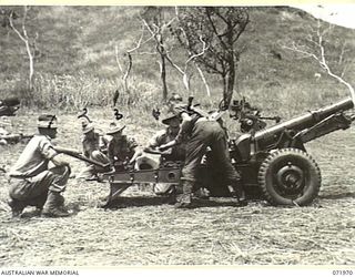 MASAWENG RIVER, NEW GUINEA. 1944-03-31. MEMBERS OF E TROOP, 64TH BATTERY, 2/14TH FIELD REGIMENT, AT GUN DRILL ON A SHORT (QUICK FIRING) 25 POUNDER GUN, SET AT MAXIMUM ELEVATION. IDENTIFIED ..