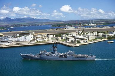 An aerial port beam view of the frigate USS BREWTON (FF 1086) leaving port at the conclusion of the designation and departure ceremony for the Unknown Serviceman of the Vietnam Era. The BREWTON is transporting the Unknown Serviceman to Naval Air Station, Alameda, California