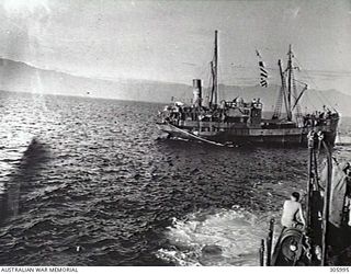 COLLINGWOOD BAY, NEW GUINEA. THE CORVETTE HMAS BROOME APPROACHING THE GROUNDED MERCHANT VESSEL COORABIE PRIOR TO TOWING HER OFF A SHOAL. (NAVAL HISTORICAL COLLECTION)