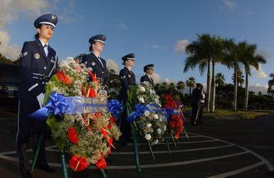 U.S. Air Force Hickam Honor Guard SENIOR Airmen Jodi Asprer, April Bonaparte, Ocasio Gonzalea, and AIRMAN 1ST Class Jennifer Kinkaid, stand by to bear the wreaths during the 63rd anniversary of the attack on Hickam Field, at Hickam Air Force Base, Hawaii, on Dec. 7, 2004. (U.S. Air Force PHOTO by Mysti Bicoy, CIV.) (Released)