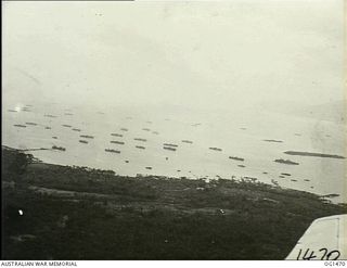 MILNE BAY, PAPUA. C. 1944-02. AERIAL VIEW OF SHIPPING IN MILNE BAY OFF THE COASTLINE, AS SEEN FROM A BEAUFORT BOMBER AIRCRAFT OF NO. 8 SQUADRON RAAF ON ANTI-SUBMARINE PATROL