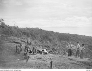 WAREO, NEW GUINEA. 1943-12. TROOPS OF THE 2/23RD AUSTRALIAN INFANTRY BATTALION, TRYING TO GET A SUNTAN DURING ONE OF THEIR STAND DOWN PERIODS. IDENTIFIED PERSONNEL ARE: VX73862 PRIVATE F. T. MADDY ..