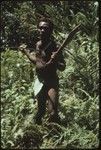 Portrait of man carrying bush knife and subi club