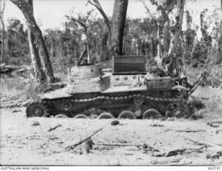 WEWAK AREA, NEW GUINEA, 1945-05-28. A SIDE VIEW OF A KNOCKED OUT JAPANESE MEDIUM TANK SHOWING DETAIL OF BOGIES AND BOGIE SUSPENSIONS, WATER COVERS OPENED, EXHAUSTS AND TURRET CONSTRUCTION, WHICH ..