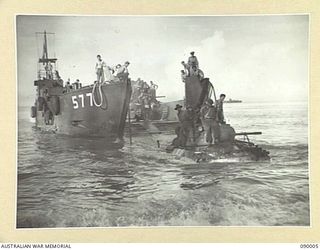 TOKO, BOUGAINVILLE. 1945-03-28. A MATILDA TANK BEING DRIVEN ASHORE THROUGH THE SEA FROM AN AMERICAN OPERATED LANDING CRAFT TANK DURING THE LANDING OF PORTION OF B SQUADRON, 2/4 ARMOURED REGIMENT IN ..