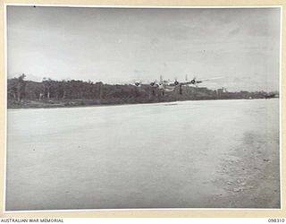 WEWAK, NEW GUINEA. 1945-10-26. A LIBERATOR AIRCRAFT, THE FIRST PLANE OF ITS KIND TO LAND AT BORAM AIRSTRIP, ARRIVING WITH GENERAL SIR THOMAS A. BLAMEY, COMMANDER-IN-CHIEF, ALLIED LAND FORCES, SOUTH ..