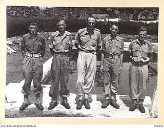 LAE AREA, NEW GUINEA. 1945-07-29. CHAPLAIN A.H. ORR (3) WITH PRIVATE I. LOHNEYER, 2/7 ADVANCED WORKSHOP (4) WHOM HE BAPTISED AT HEADQUARTERS LAE BASE SUB-AREA. IDENTIFIED PERSONNEL ARE:- PRIVATE R. ..