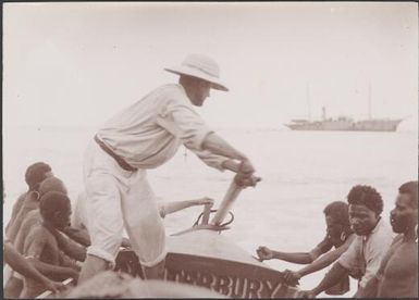 Solomon Islanders launching boat with the Bishop at the steering oar, Te Motu, Santa Cruz Group, Solomon Islands, 1906 / J.W. Beattie