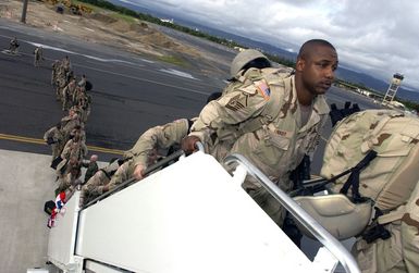 US Air Force (USAF) MASTER Sergeant (MSGT) Kenneth Lindsey, with the 25th Air Support Operations Squadron (ASOS), boards an aircraft at Hickam Air Force Base (AFB), Hawaii, for deployment to an undisclosed location