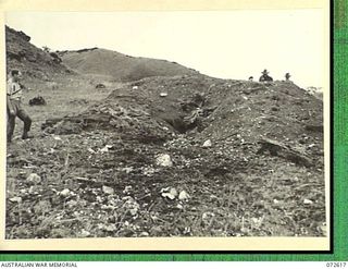 WANDOKAI, NEW GUINEA. 1944-04-18. THE EFFECT OF 27 ROUNDS FIRED FROM THE 3 INCH HOWITZER OF A MATILDA TANK AT A JAPANESE TYPE COCONUT LOG BUNKER. MEMBERS OF THE 1ST TANK BATTALION PROVIDED THE FIRE ..