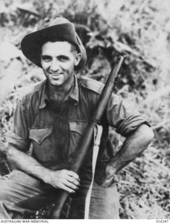 NEW GUINEA. 3 DECEMBER 1945. FALL OF JAPANESE HELD SATTELBERG. AUSTRALIAN TROOPS STORMED THE STEEP HEIGHTS TO WREST THE VILLAGE OF SATTELBERG FROM THE JAPANESE. SGT. T.C. DERRICK D.C.M. OF ..