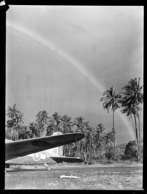 Side view of a C47 transport plane and rainbow, Faleolo Airport, Western Samoa