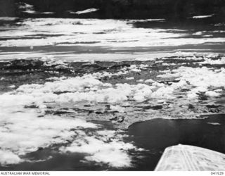 NEW GUINEA. 1949-09. THE KOKODA TRAIL IS SHOWN IN THIS INFRA-RED AERIAL PHOTOGRAPH TAKEN FROM A POINT APPROXIMATELY 10 MILES SOUTHWEST OF PORT MORESBY, AT A HEIGHT OF 12,500 FEET. THE PACIFIC ..