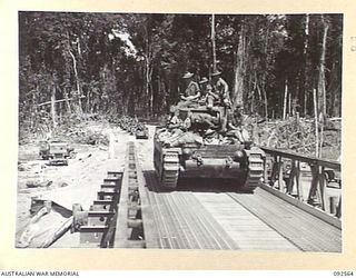 BOUGAINVILLE. 1945-05-23. A MATILDA TANK OF A SQUADRON, 2/4 ARMOURED REGIMENT, CROSSING THE NEW MCKINNA BRIDGE OVER THE PURIATA RIVER. THIS AUSTRALIAN PANEL BRIDGE WAS THE FIRST OF ITS TYPE USED IN ..