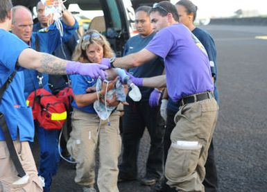 Earthquake ^ Tsunami - Pago Pago, American Samoa, October 5, 2009 -- Members of a Disaster Medical Assistance Team (DMAT) rush an infant onto a Coast Guard plane that will evacuate the infant to Hawaii. DMATs are part of the U. S. Department of Health and Human Services' National Disaster Medical System which supports hospitals and other medical and public health needs of communities during disasters such as the earthquake and tsunami disaster in American Samoa. FEMA/Casey Deshong