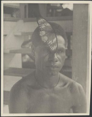 Aiau wears a live butterfly in his hair, Rabaul, New Guinea, ca. 1936 / Sarah Chinnery