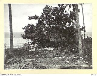 MADANG, NEW GUINEA. 1944-06-27. TROOPS GATHERED NEAR THE WASHING WELL AT THE 5TH DIVISION RECEPTION CAMP