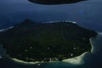 Aerial view of island off Sepik coast, shows rim of coral reef, Oct 1961
