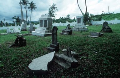 Headstones at Sumay Memorial Cemetery display damage sustained during an earthquake that struck the region on August 8th