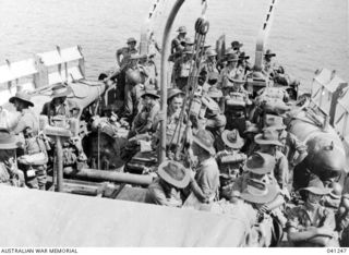 AT SEA OFF PAPUAN COAST. 1942-12-14. MEMBERS OF THE A.I.F. GOING INTO BUNA ABOARD H.M.A.S. BROOME