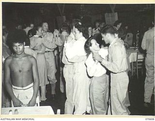 PORT MORESBY, PAPUA, 1944-02-25. A DANCE AT THE OFFICERS' CLUB. THE CLUB IS PATRONIZED BY AUSTRALIAN AND AMERICAN OFFICERS AND NURSES