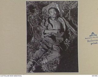 WEWAK POINT, NEW GUINEA, 1945-05-11. THE BODY OF A DEAD JAPANESE SOLDIER. THE PHOTOGRAPH WAS REQUIRED BY INTELLIGENCE, 6 DIVISION FOR IDENTIFICATION PURPOSES. 2/4 INFANTRY BATTALION TROOPS NOW ..