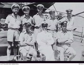 OCEAN ISLAND. 1945-10-01. LIEUTENANT COMMANDER M. G. ROSE, COMMANDER HMAS DIAMANTINA, WITH A GROUP OF HIS OFFICERS, AFTER THE SURRENDER CEREMONY HELD ABOARD HMAS DIAMANTINA WHEN LIEUTENANT ..