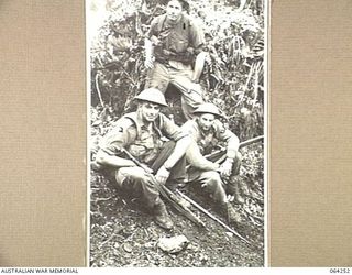 FINISTERRE RANGES, NEW GUINEA. 1944-01-23. PERSONNEL OF "D" COMPANY, 2/9TH INFANTRY BATTALION WAITING TO MOVE INTO ACTION DURING THE BATTLE FOR SHAGGY RIDGE. THEY ARE:- NX163018 PRIVATE J. BOULDING ..