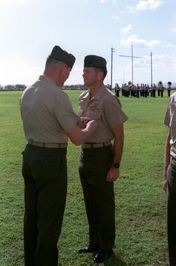 Major General Joseph J. Went awards the Meritorious Service Medal to Major Merrit