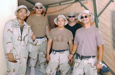 US Air Force (USAF) Airmen assigned to the 254th Civil Engineer Squadron (CES), Guam (GU), Air National Guard (ANG) deployed with the 384th Air Expeditionary Group (AEG) pose for a group photograph at a forward location while deployed in support of Operation ENDURING FREEDOM