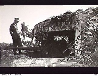 NAURU ISLAND. 1945-09-14. MEMBERS OF THE 31/51ST INFANTRY BATTALION INSPECTING AN 80MM COASTAL GUN EMPLACEMENT (JAPANESE) SOON AFTER THEIR OCCUPATION OF THE ISLAND