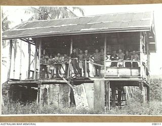 FINSCHHAFEN, NEW GUINEA, 1943-10-02. LEANING ON THE RAIL, TROOPS OF THE 9TH AUSTRALIAN DIVISION IN POSSESSION OF AN ABANDONED JAPANESE "Q" STORE COMPLETE WITH EQUIPMENT