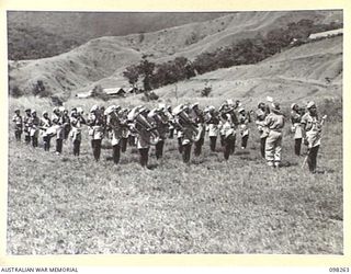 NADZAB, NEW GUINEA. 1945-10-25. THE BAND OF 3 NEW GUINEA INFANTRY BATTALION, PACIFIC ISLANDS REGIMENT, PLAYING DURING THE VISIT OF GENERAL SIR THOMAS A. BLAMEY, COMMANDER-IN-CHIEF, ALLIED LAND ..