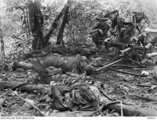 FARIA VALLEY, NEW GUINEA, 1943-10-17. A JAPANESE TYPE 92 "WOODPECKER" MACHINE GUN AND BODIES OF DEAD GUN CREW, AFTER A SUCCESSFUL ACTION AT TREVOR'S RIDGE BY THE 2/27TH AUSTRALIAN INFANTRY ..