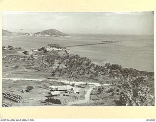 PORT MORESBY, NEW GUINEA. 1944-06-27. DISTILLATE FILLING PLATFORM (FOREGROUND) THE A AND C BULK STORAGE TANKS (BACKGROUND) AND THE OIL JETTY OF THE 1ST BULK PETROLEUM STORAGE COMPANY. TO JOIN TO ..