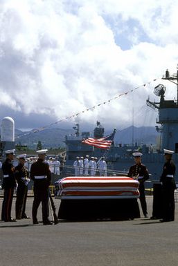 A Marine Corps honor guard stands by the casket of the Unknown Serviceman of the Vietnam Era during the designation and departure ceremony. After the ceremony, the Unknown Serviceman will be placed aboard the frigate USS BREWTON (FF 1086) for transport to Naval Air Station, Alameda, California