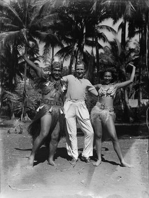 [Portrait of couple in Tahitian costume, with photographer]