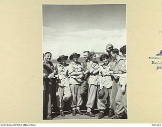 LAE, NEW GUINEA, 1945-05-07. TROOPS AND AUSTRALIAN WOMEN'S ARMY SERVICE WHO TRAVELLED TOGETHER ON THE MV DUNTROON FROM AUSTRALIAN SAYING GOOD-BYE BEFORE DISEMBARKATION AT MILFORD HAVEN. THE ..