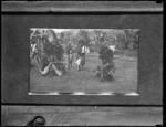 Three men with feather head dress, one child.