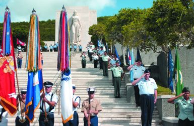 A multi-service Color Guard presents the Colors on the steps of the National Memorial Cemetery of the Pacific, at Oahu, Hawaii (HI) during a Memorial Day Ceremony held to honor military members buried there