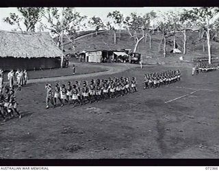 BISIATABU, NEW GUINEA. 1944-04-19. PP1 MAJOR GENERAL B. M. MORRIS DSO, GENERAL OFFICER COMMANDING AUSTRALIAN NEW GUINEA ADMINISTRATIVE UNIT (ANGAU), TAKING THE SALUTE DURING THE MARCH PAST OF ..